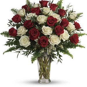 Red and white roses in a clear vase