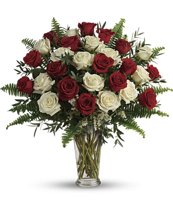 Red and white roses in a clear vase